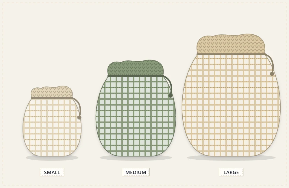 Three small mesh produce bags in three sizes with their drawstrings pulled closed