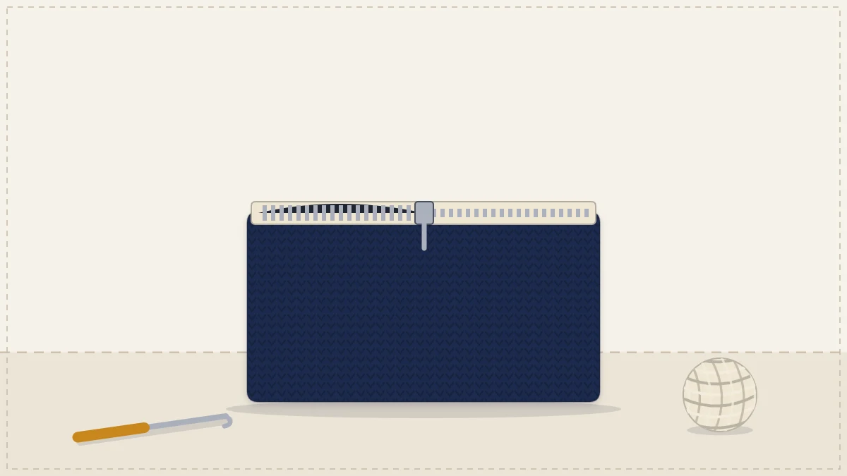 A flat rectangular crocheted pouch with a zipper along the top edge, half open, in navy with a cream zipper